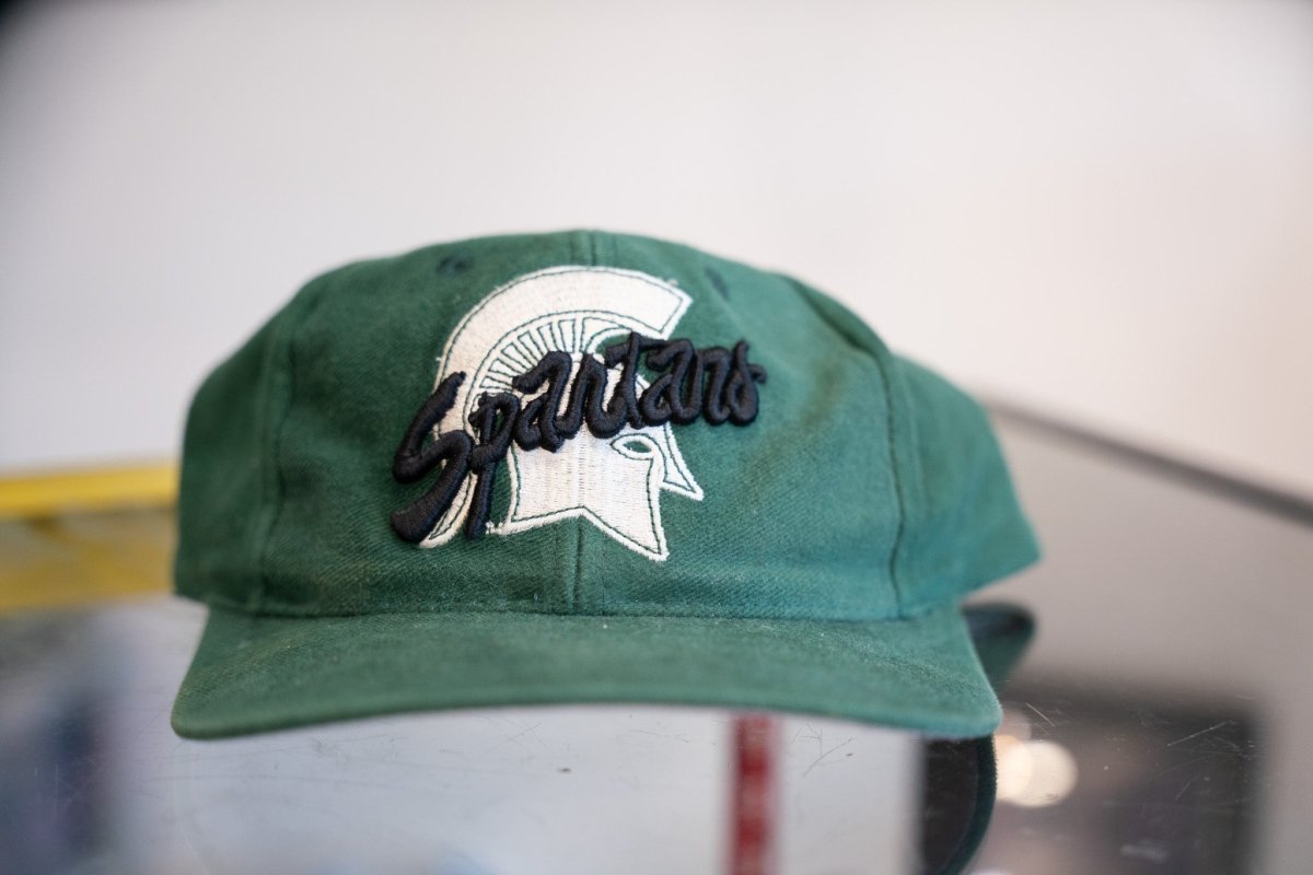 Forest green vintage TOW Michigan State Spartans snapback hat with white embroidered Spartan helmet logo and black Spartans script overlay