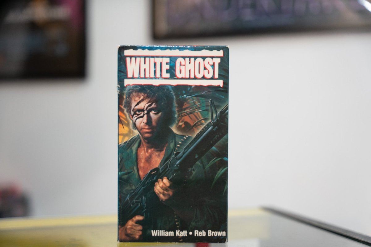 White Ghost VHS dark jungle sleeve with war-painted soldier holding rifle explosion background white red WHITE GHOST title William Katt Reb Brown credits