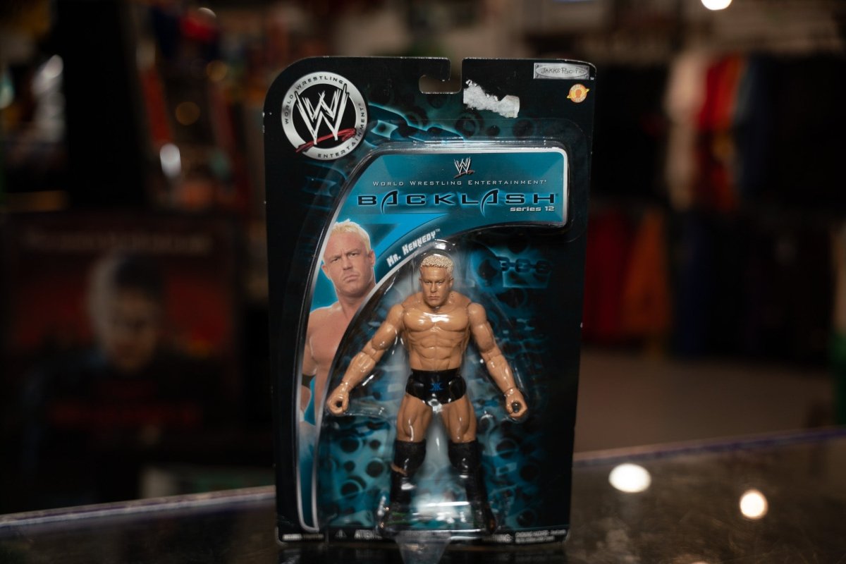 WWE Backlash Series 12 action figure with blonde hair wearing black and silver wrestling attire with microphone prop, circa 2007