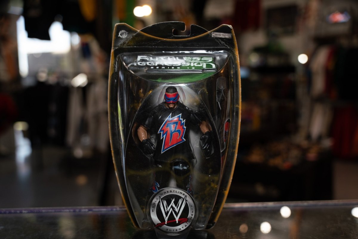 WWE Ruthless Aggression Series 13 Rosey action figure with blue and red costume, muscular build, and articulated joints displayed against white background