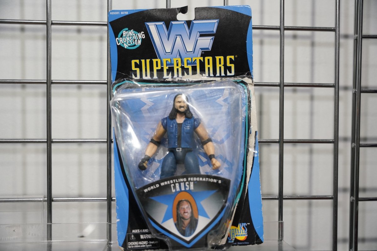 WWF Superstars Crush action figure on blue card by Jakks Pacific in biker denim vest and dark pants with Bone Crunching Action badge