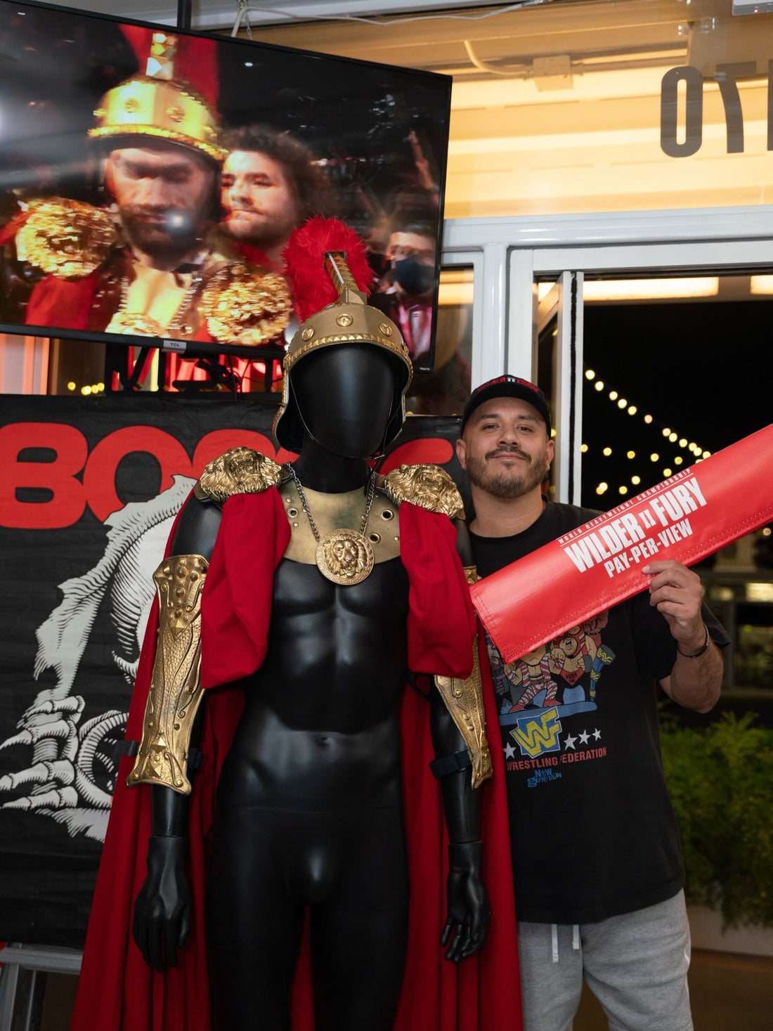 Tyson Fury's Wilder II Spartan walkout uniform displayed at the Keep It Classic WrestleCon 2026 booth.