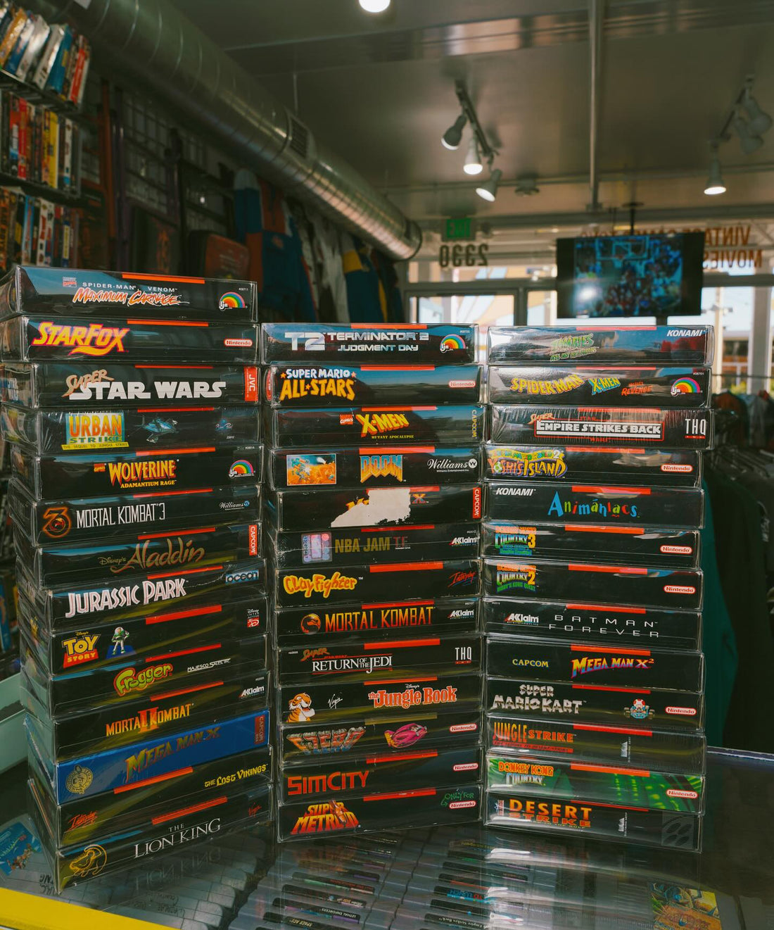 A stack of Complete-in-Box Super Nintendo games at Keep It Classic