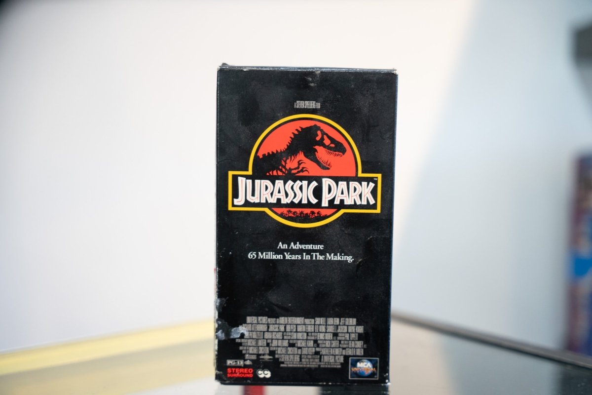 Jurassic Park VHS clamshell case, 1990s release, photographed on the grading bench.