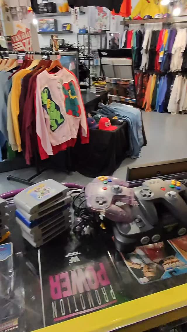 Vintage wrestling figures and N64 carts on the counter at Keep It Classic
