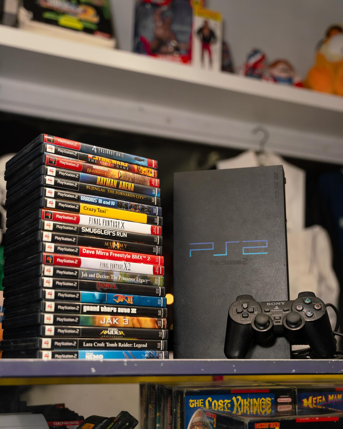 PS2 console with tower of PlayStation game cases at Keep It Classic