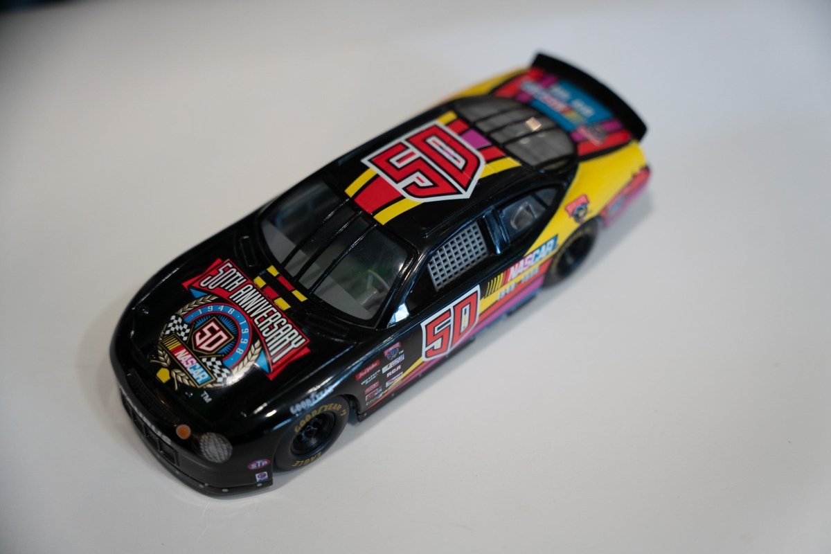 Racing Champions NASCAR Ford Taurus 50th Anniversary commemorative diecast car in 1:24 scale with white and blue livery displayed against neutral background