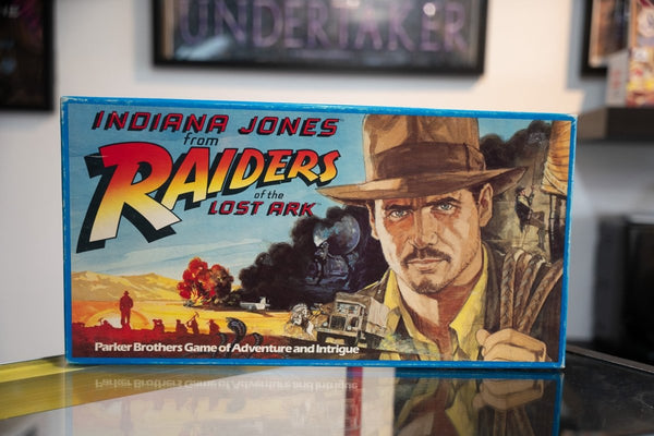 1982 Indiana Jones Raiders of the Lost Ark Parker Brothers board game blue box with painted Harrison Ford fedora explosion train adventure art