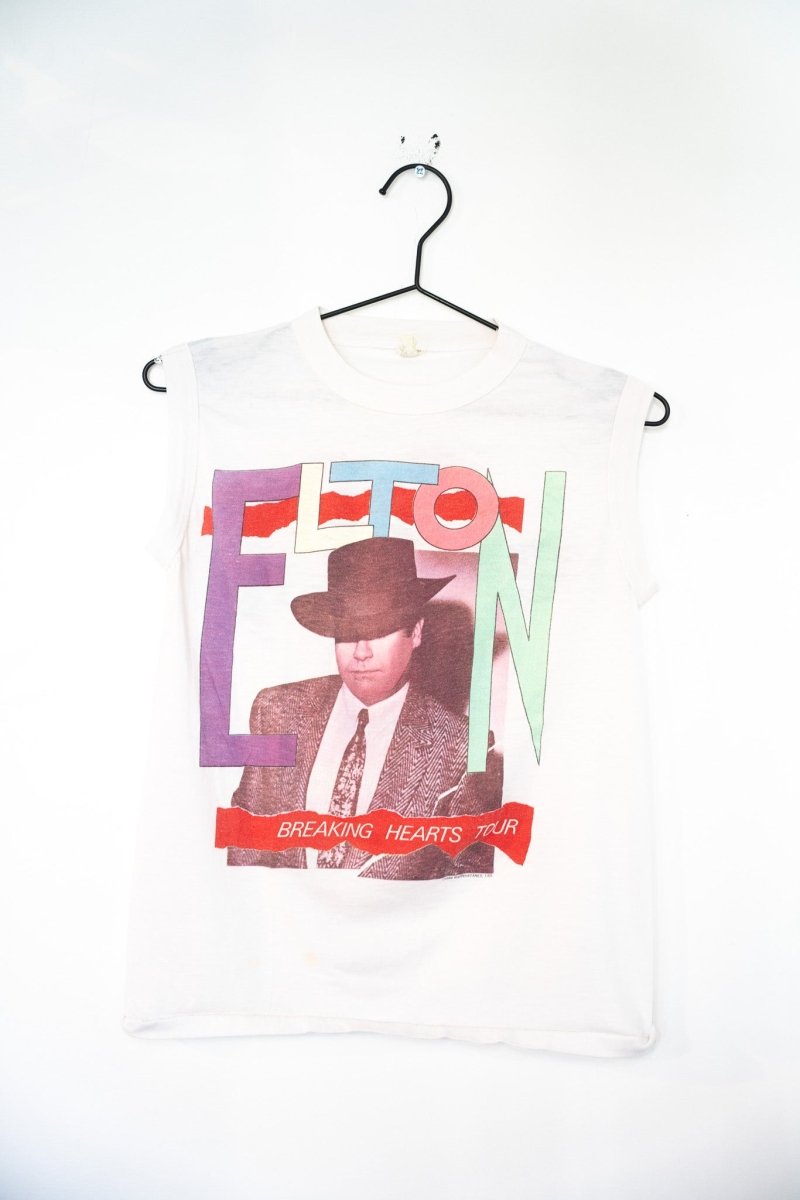 White 1984 Elton John Breaking Hearts Tour sleeveless muscle tee with multicolor pastel ELTON block letters and Elton in cowboy hat photo size M