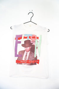 White 1984 Elton John Breaking Hearts Tour sleeveless muscle tee with multicolor pastel ELTON block letters and Elton in cowboy hat photo size M