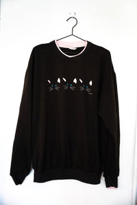 Black 1985 Kitty Boy Eyes and Ears Acton sweatshirt with three pairs of blue cat eyes and ears peeking up and pink collar trim