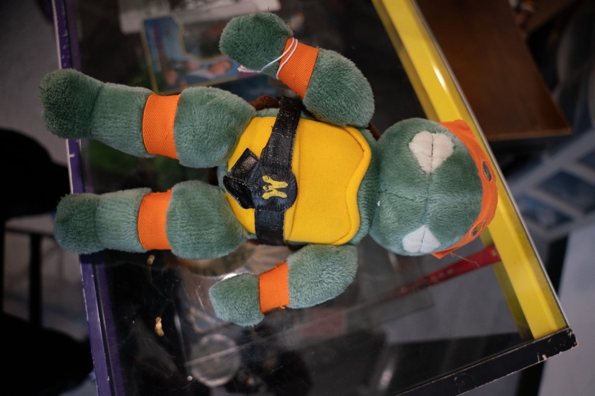 1989 Teenage Mutant Ninja Turtles Michelangelo green plush with orange mask and pads yellow chest and black M strap by Playmates
