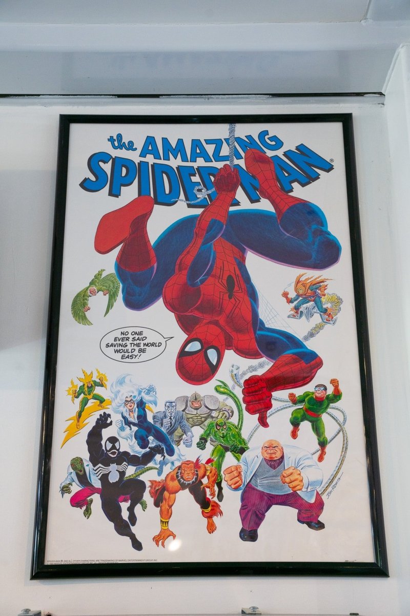 Framed 1990 Amazing Spider-Man Villains poster by John Romita with Spider-Man swinging surrounded by Venom Doctor Octopus Vulture Kingpin Electro villains