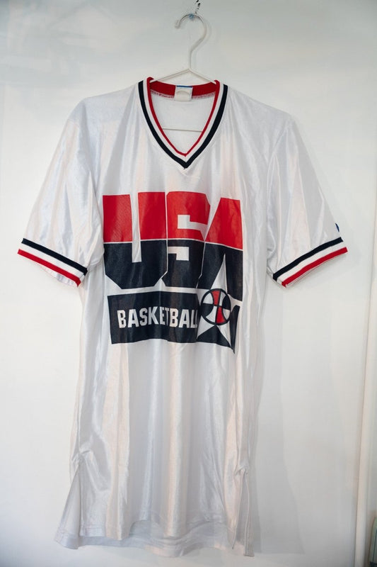 White 1992 Champion Team USA Basketball mesh warm-up jersey with large red navy USA lettering striped V-neck collar and sleeve cuffs size Medium