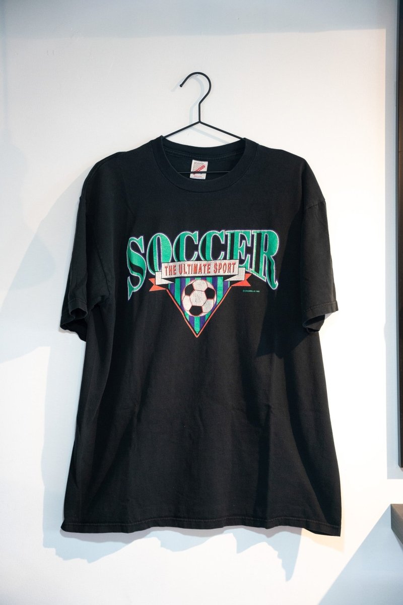 Black 1992 Soccer The Ultimate Sport tee with green SOCCER serif text red banner soccer ball inverted triangle geometric design size XL