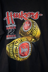 Salem Sportswear 1993-94 Nebraska Huskers Back 2 Back National Champions XXL shirt with printed text and graphics on red fabric