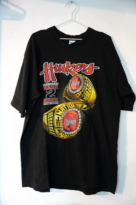Black 1993-94 Salem Nebraska Huskers Back 2 Back National Champions tee with red Huskers script two gold championship rings graphic size XXL