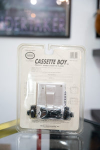 Nintendo Cassette Boy handheld game console in sealed original packaging from 1993, showing yellow and black device with screen visible through clear plastic box