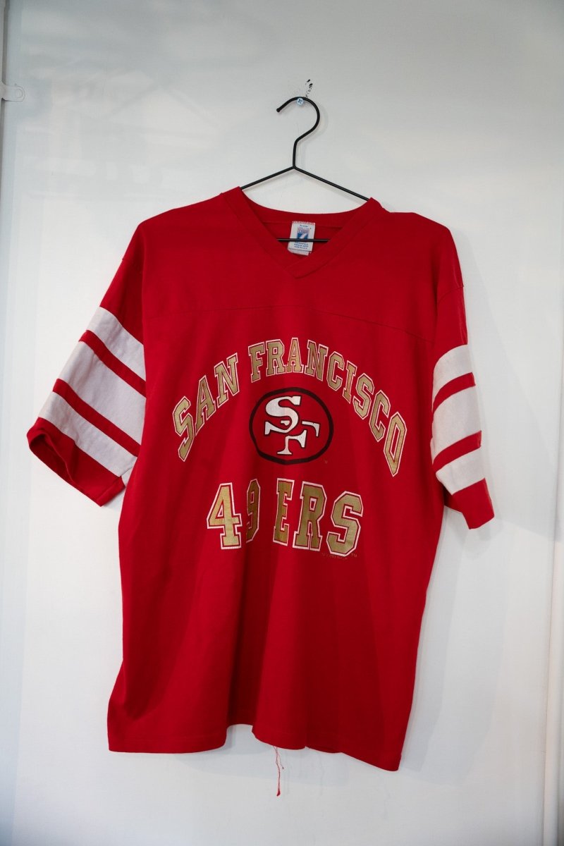 Red 1993 San Francisco 49ers Logo 7 V-neck t-shirt with gold SAN FRANCISCO arched text SF oval logo gold 49ERS lettering and white striped sleeves size Large