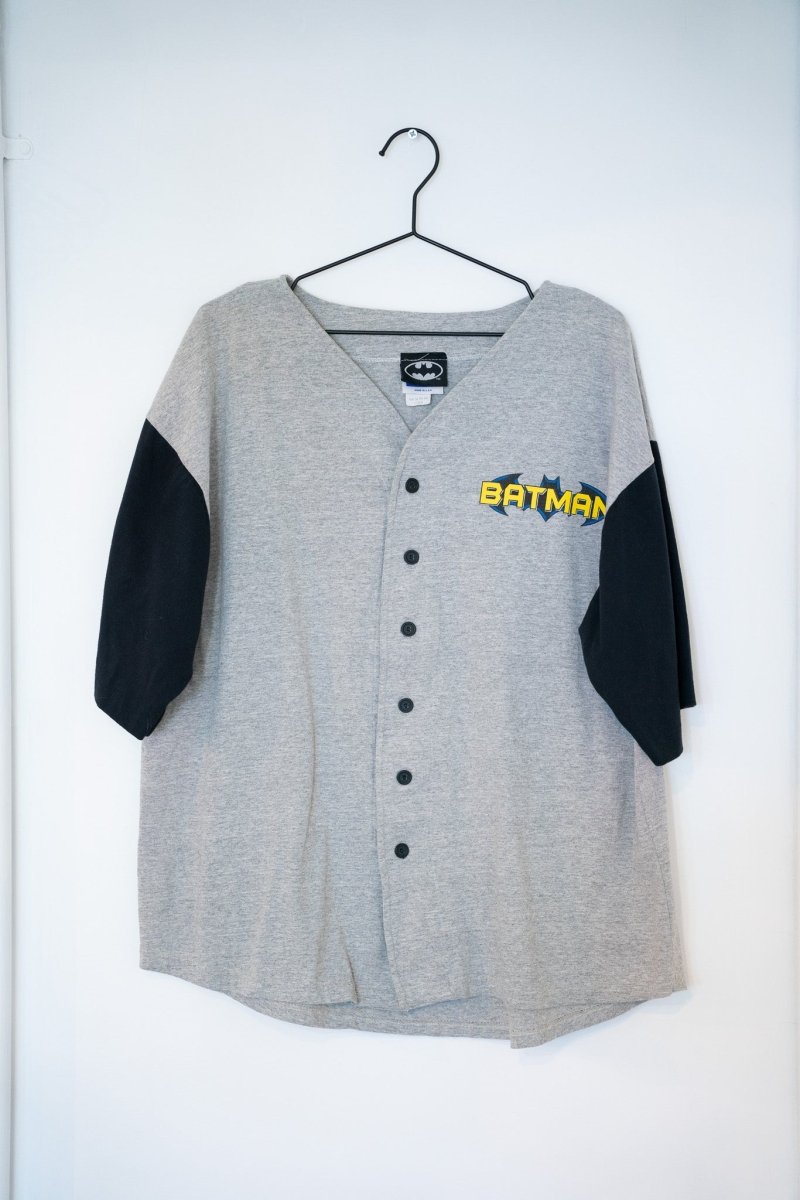 Gray and black 1996 Trevco Batman baseball jersey button-front black raglan sleeves yellow blue BATMAN comic logo left chest