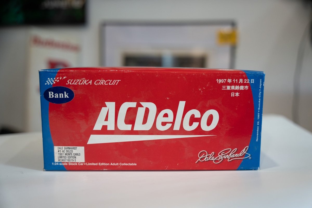 NASCAR Action Diecast 1/24 scale die-cast bank featuring #3 AC Delco race car livery from 1997, metallic finish with detailed racing graphics and Suzuka Circuit branding on collectible toy vehicle