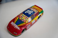 Revell 1:24 scale diecast stock car #36 Skittles Pontiac, 1997 NASCAR Derek Cope model with white and multicolored livery
