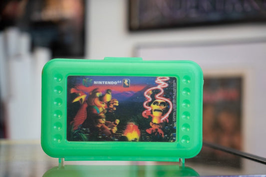 Green 1998 Banjo-Kazooie Nintendo 64 pencil box with holographic lenticular campfire scene sticker on lid with N64 and Rareware logos