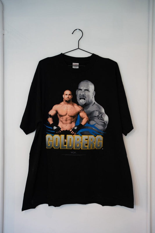 Black 1998 WCW Goldberg tee dual image portrait shirtless muscular screaming close-up blue tribal flames gold GOLDBERG text Cottonnet