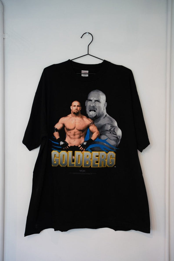 Black 1998 WCW Goldberg tee dual image portrait shirtless muscular screaming close-up blue tribal flames gold GOLDBERG text Cottonnet