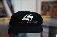 Black 1998 Lost in Space promotional snapback hat with silver LS monogram and orange LOST IN SPACE embroidered text