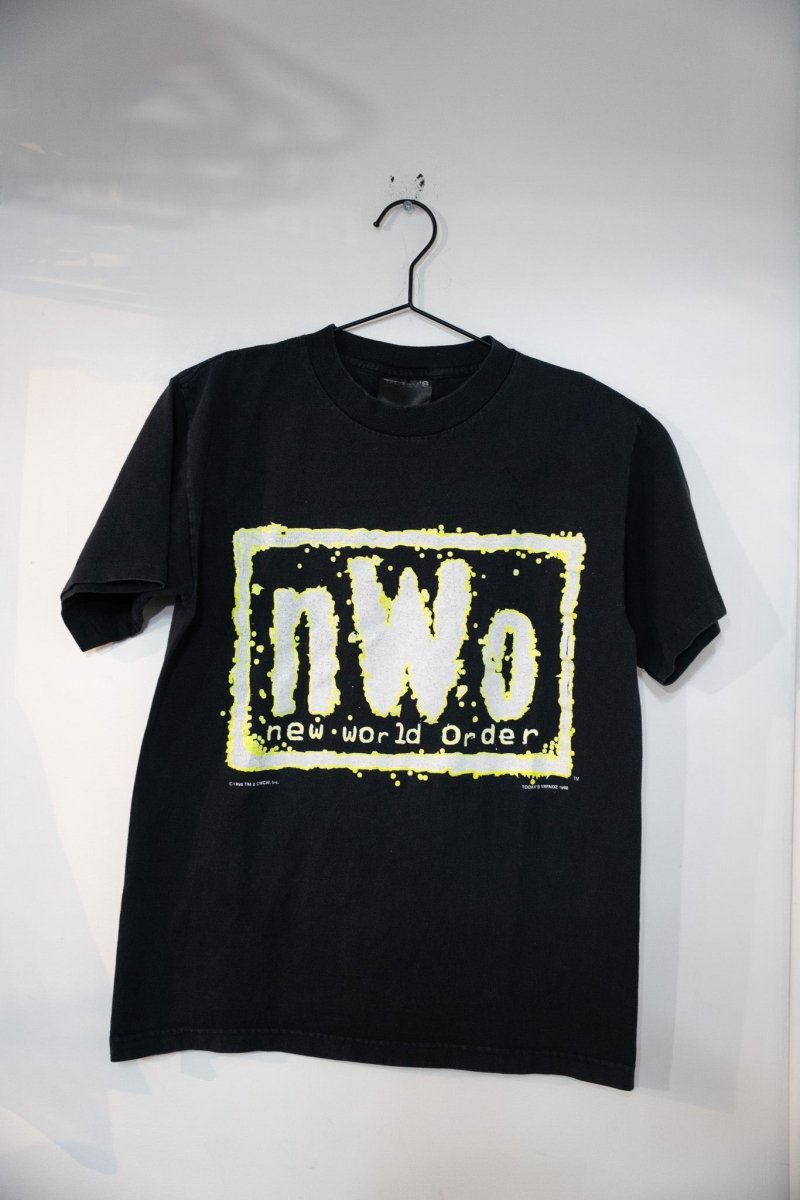 Black 1998 WCW NWO glow in the dark shirt with white nWo logo and yellow-green spray paint border