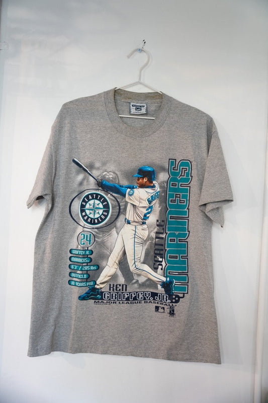 Heather gray 1999 Lee Sport Seattle Mariners Ken Griffey Jr bio t-shirt with full-body swing illustration Mariners logo stat panel and teal SEATTLE MARINERS text size Large