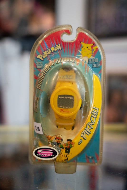 1999 Pikachu Pokemon C-Watch sealed in blister pack with yellow digital watch and red and teal Pokemon backer card with Ash and Pikachu art