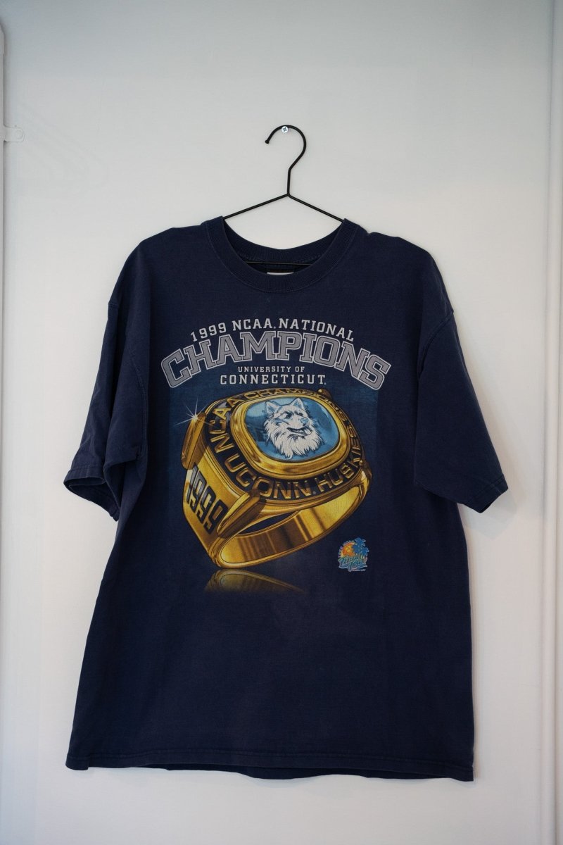 Navy 1999 Pro Player UConn Huskies NCAA National Champions tee gold championship ring graphic husky mascot CHAMPIONS metallic text