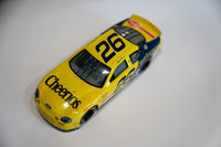 Racing Champions NASCAR #26 Cheerios die-cast Ford Taurus 1/64 scale model from 1999, yellow and red livery on white card packaging