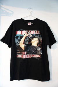 Black 2000 WWF The Rock tee with DO YOU SMELL WHAT THE ROCK IS COOKIN text Rock holding microphone Brahma Bull skull WWF logo size Large
