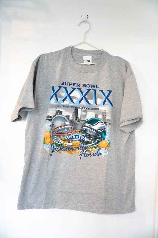 Heather gray 2005 Super Bowl XXXIX shirt with Patriots and Eagles helmets facing off over Jacksonville skyline with blue XXXIX numerals