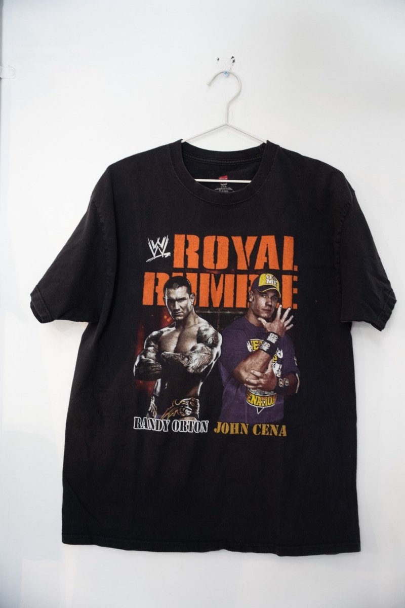 WWE 2011 Royal Rumble graphic t-shirt, size large, featuring wrestlers in blue and red design on dark fabric