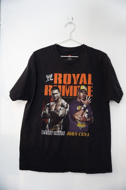 WWE 2011 Royal Rumble graphic t-shirt, size large, featuring wrestlers in blue and red design on dark fabric