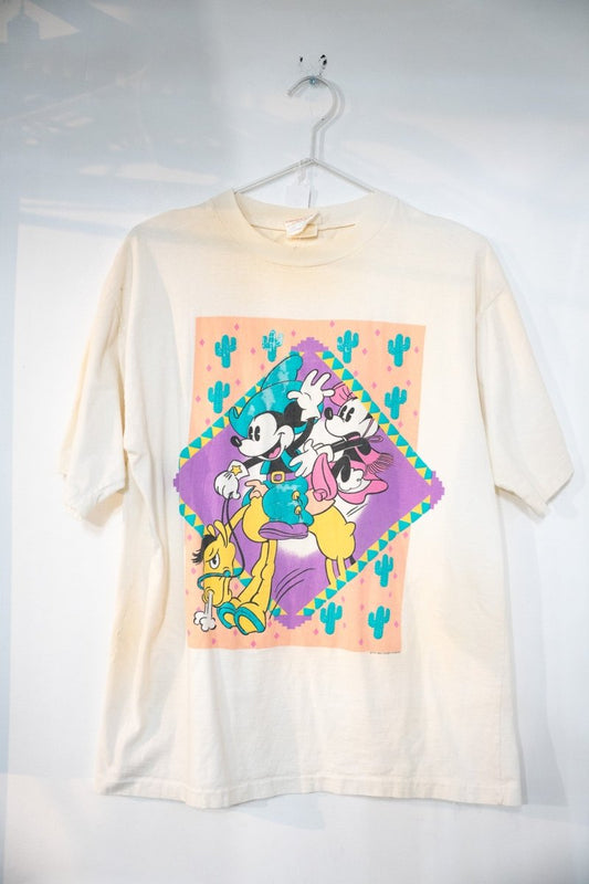 Cream 80s Disney Mickey Mouse Western themed t-shirt with cowboy Mickey Minnie riding Pluto in diamond frame with teal cactus and peach purple Southwestern patterns size Large