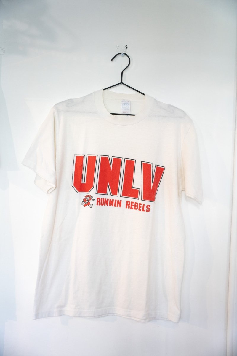 White 80s UNLV Runnin Rebels t-shirt with large red UNLV block lettering and running Hey Reb mascot size Large