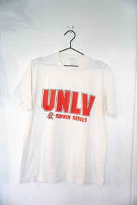 White 80s UNLV Runnin Rebels t-shirt with large red UNLV block lettering and running Hey Reb mascot size Large