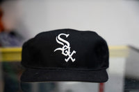 All-black 90s Chicago White Sox snapback hat with white embroidered gothic Old English Sox logo on front panel