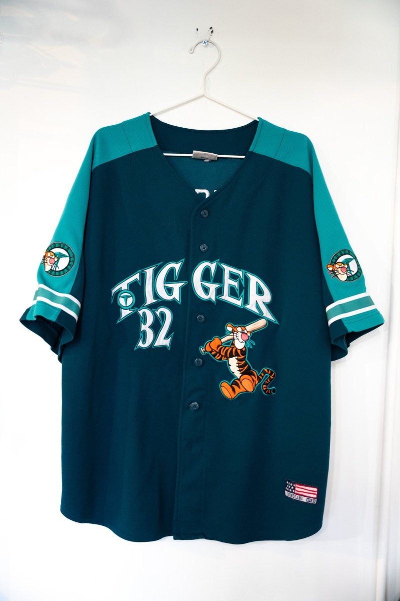 Dark teal 90s Disney Tigger baseball jersey in Seattle Mariners style with embroidered Tigger batting and number 32 and Tigger sleeve patches