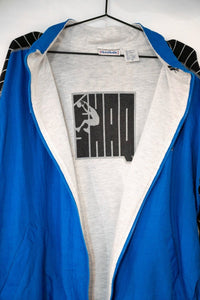 Reebok black nylon jacket from the 1990s, size XL, featuring a colorblock design with white and red accents on the sleeves and torso
