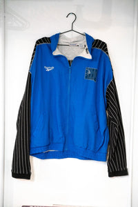 Royal blue 90s Reebok Shaq windbreaker jacket black white pinstripe sleeves SHAQ dunk logo Reebok logo full-zip gray collar size XL