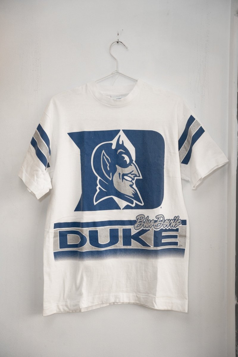 White 90s Salem Duke Blue Devils tee massive blue D logo Blue Devil mascot silver script DUKE block text blue silver sleeve stripes