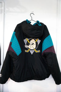 Starter Anaheim Mighty Ducks colorblock anorak jacket from the 1990s, featuring purple and teal nylon with quilted puffer sleeves and NHL hockey branding