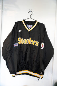 Black 90s Starter Pro Line Pittsburgh Steelers nylon pullover jacket with gold embroidered Steelers script and striped ribbed collar