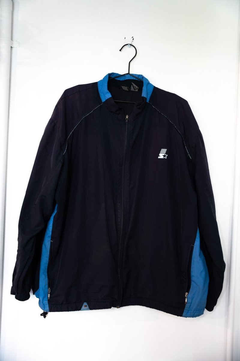 Black 90s Starter windbreaker jacket with blue side panels and collar white S star logo on left chest zippered pockets size XL